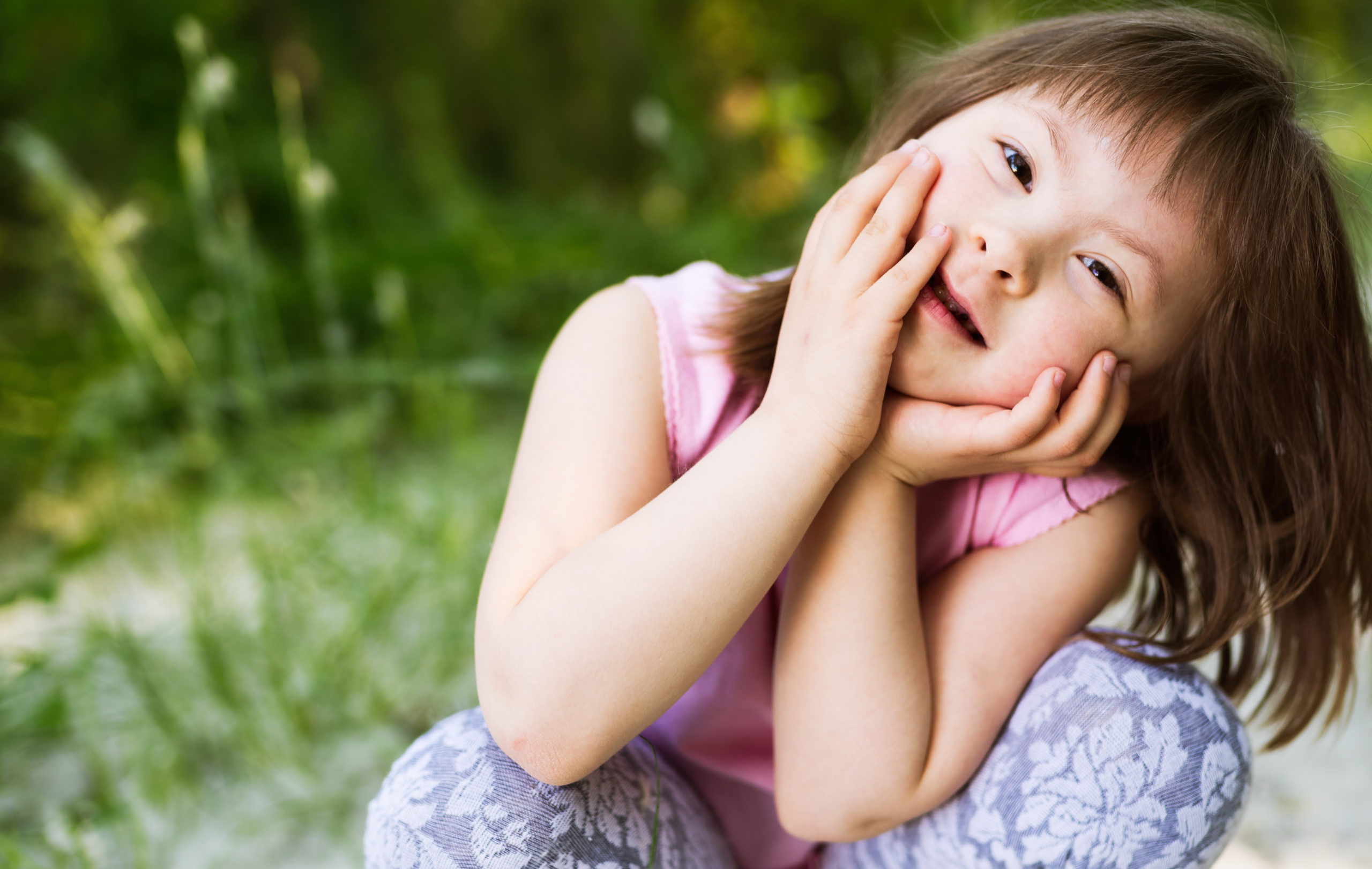 Portrait of beautiful little girl with down syndrome