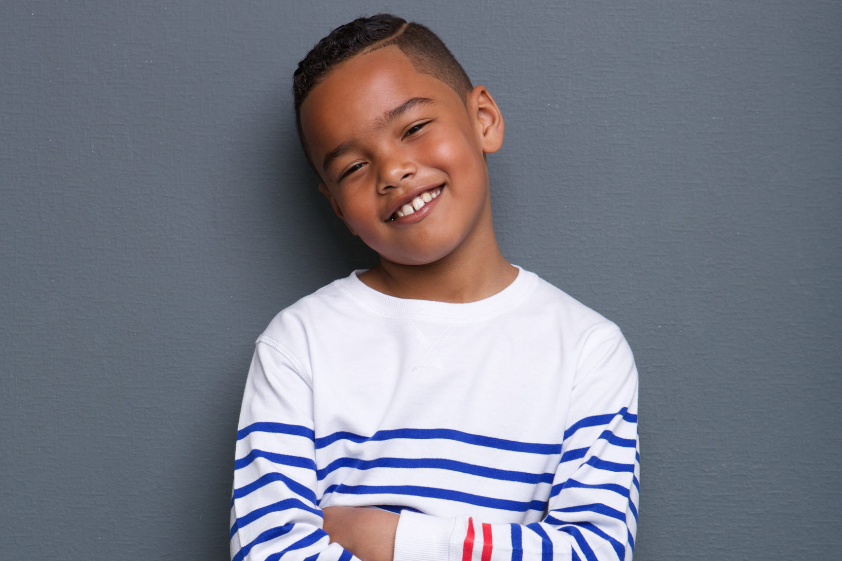 Smiling little boy with arms crossed